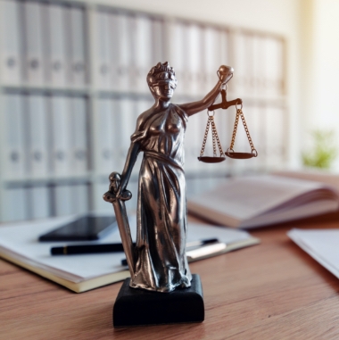 Mini Lady Justice statue symbolizes Zunder & Associates' criminal defense team.