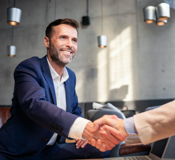 A picture of a lawyer shaking hands to his client